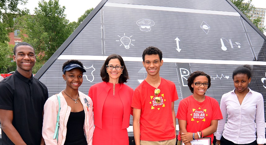 Anne Pramaggiore, ComEd's president and CEO, (third from left) poses in front of the Solar Spotlight Pyramid with a few of the students from ComEd’s Solar Spotlight Education Program.